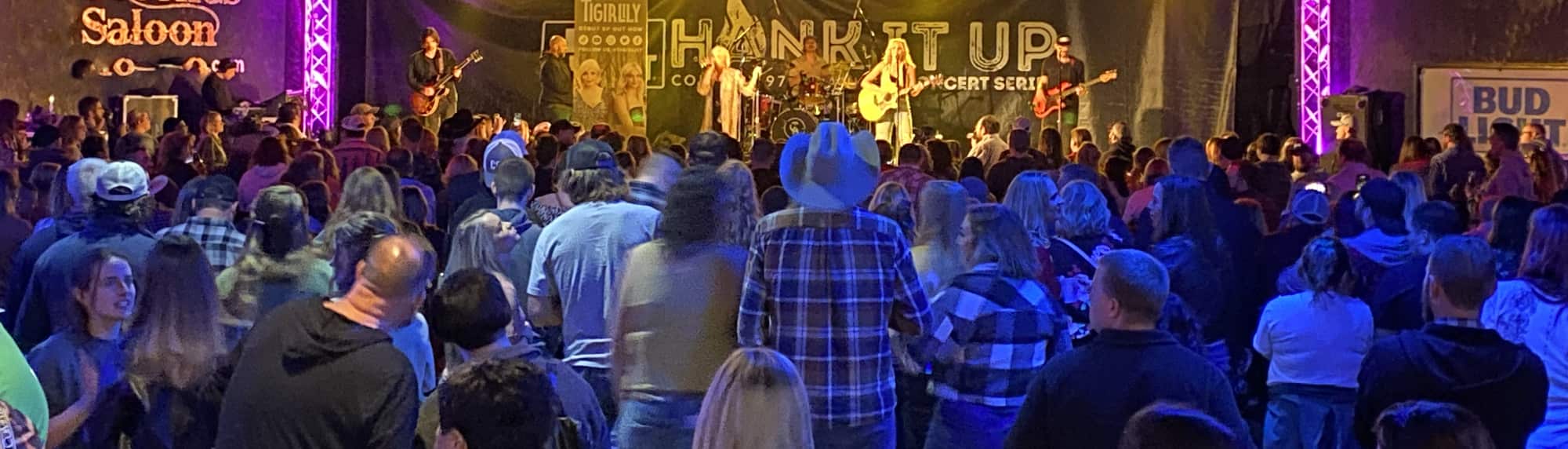 country concert with fans wearing cowboy hats Jacksonville